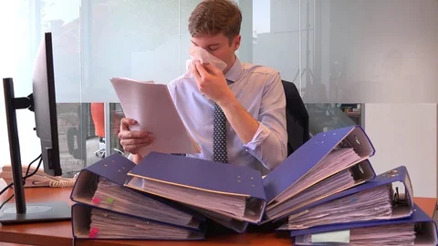 Sick having cold flu employer accountant blowing nose indoors paperwork stack 4K Stock Footage 82314473