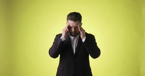 Sick ill bearded man in office suit putting hands on head having headache. Stock Footage 148990178