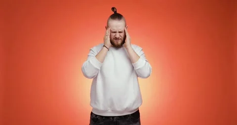 Sick ill bearded man in white sweater putting hands on head having headache. Stock Footage 149034239