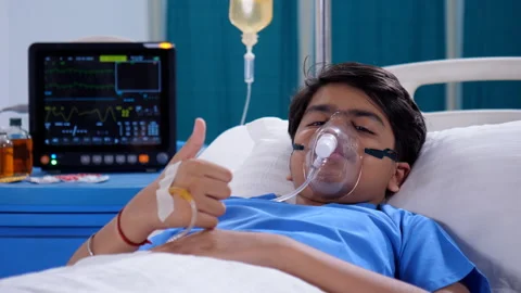 A sick Indian boy is doing a thumbs-up gesture while relaxing in the hospital... Stock Footage 260815484