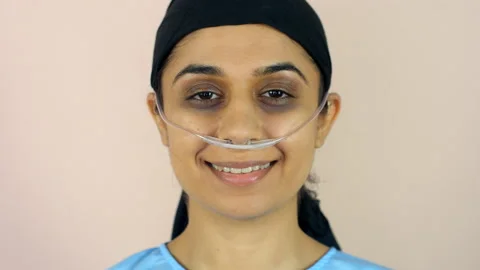 A sick Indian female smiling while recovering from her illness - chemotherapy... Stock Footage 200770735