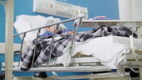 Sick kid at hospital bed Stock Footage