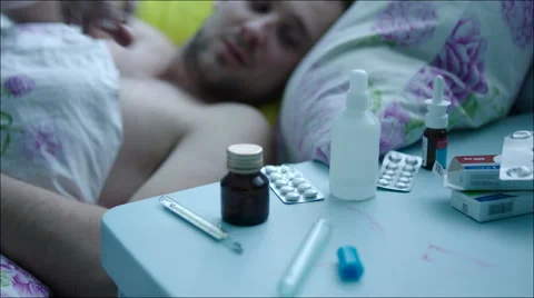 Sick Man in Bed Taking Pills Stock Footage 60380610