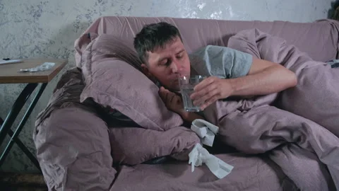 Sick man with cold, flu or virus illness drinking pill or drug for health Stock Footage 236639174