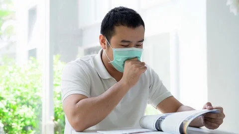 Sick Man Coughing and Clearing His Throat While Reading 動画素材 126825879