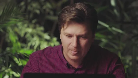Sick man coughs at home while sitting at laptop Stock Footage 150150717