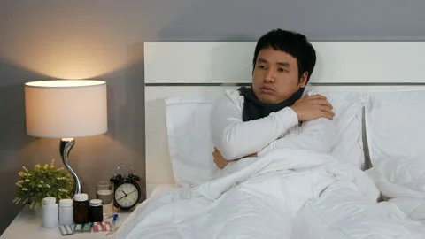 Sick man feeling cold in a bed Stock Footage 130723806