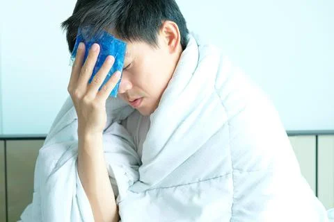 Sick man is flu, using a paper napkin and he have a runny nose. And he was co Stock Photos