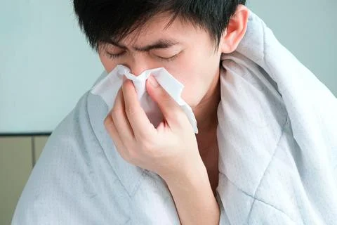 Sick man is flu, using a paper napkin and he have a runny nose. And he was .. Stock Photos