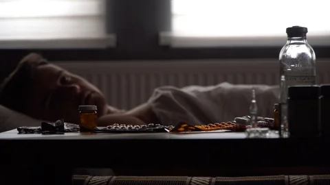 Sick man looking for the right medication on the table Stock Footage 125809933