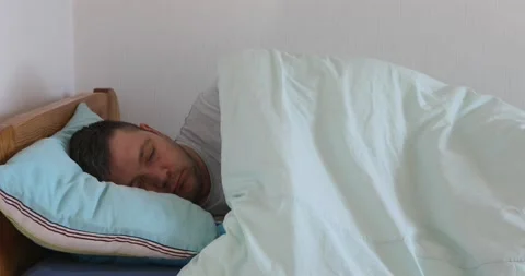 Sick man Lying in bed, not feeling well. Hurts. Stock Footage 165946328