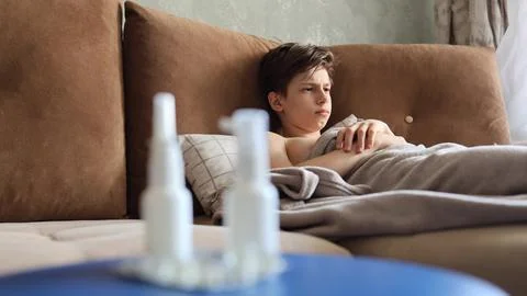 Sick man lying in bed suffering virus having medicine tablets. drinking pill Stock Photos