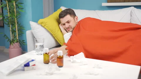 The sick man is lying on the sofa sick, tired, exhausted  Video stock 233041110