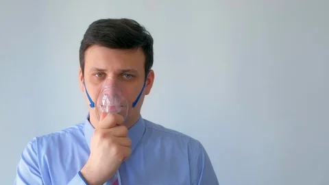 Sick man in oxygen mask due to difficulty in breathing in coronavirus pandemic. Stock Footage 129137833