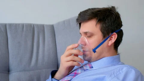 Sick man in oxygen mask due to difficulty in breathing in coronavirus pandemic. Stock Footage 129140159