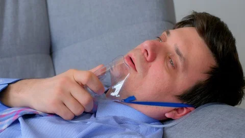 Sick man in oxygen mask due to difficulty in breathing in coronavirus pandemic. Stock Footage 129140606