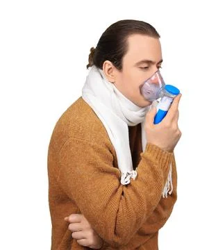 Sick man in scarf using nebulizer for inhalation treatment isolated on whit.. Stock Photos
