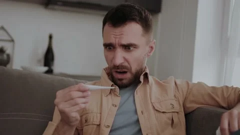 Sick man shocked by the temperature on the thermometer Video stock 160929330