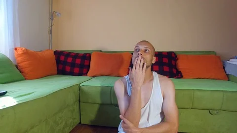 Sick man sitting on the floor of his room feeling depressed and abandoned Stock Footage 111018527