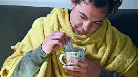 Sick man stunned stoned soaking the blister packs of tablets in the cup Stock Footage 105262855
