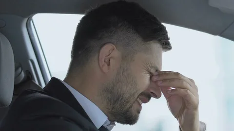 Sick man taking off glasses in car, bad eyesight problem, high blood pressure Video stock 117222997