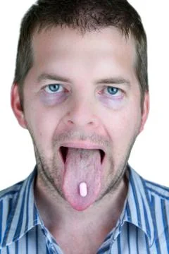 Sick man taking a pill Stock Photos