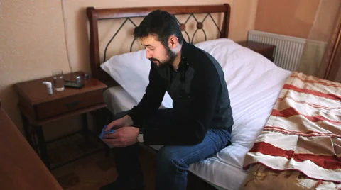 Sick man taking  pill while sitting on bed. Dynamic shot 스톡 동영상 59888845