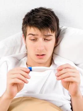 Sick Man with a Thermometer Stock Photos