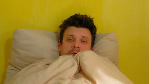 Sick man waking up with headache, sars, cold, coronavirus, portrait closeup. Stock Footage 128958969