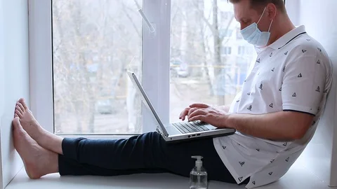 A sick man works at home on a computer Stock Footage 128002588