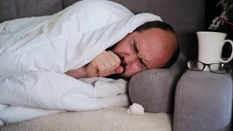 Sick man wrapped with blanket during covid outbreak. Stock Footage 145915874