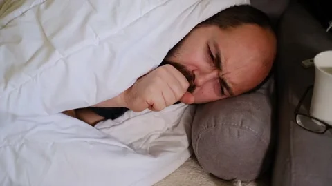 Sick man wrapped in a blanket during the coronavirus outbreak. Stock Footage 145915875