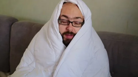 Sick man wrapped with blanket during covid outbreak. Stock Footage 145915894