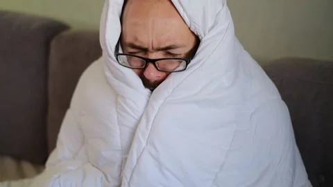Sick man wrapped with blanket during covid outbreak. Stock Footage 145915895