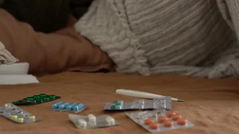 Sick mans hand take cup and thermometr Stock Footage 165689904