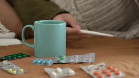 Sick mans hand take cup and thermometr Stock Footage 165883446
