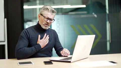 Sick mature gray haired bearded businessman in glasses has heartache sitting at  Stock Footage 232580924