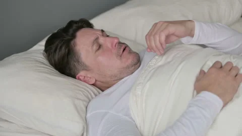 Sick Middle Aged Man with Cough Laying in Bed Video stock 142367709