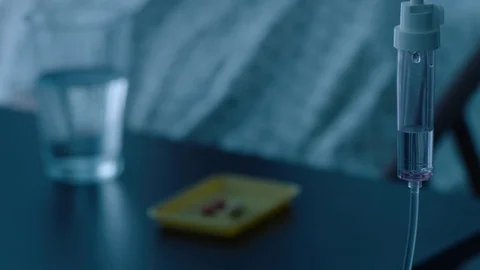 A sick middle aged man taking medication pills in a hospital bed, slow motion, Stock Footage 74398649