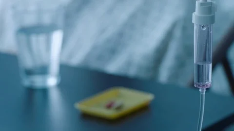A sick middle aged man taking medication pills in a hospital bed, slow motion, Stock Footage 74398908
