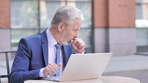 Sick Old Businessman Coughing while Working on Laptop, Outdoor Stock Footage 111799739