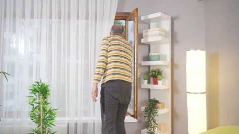 Sick old man looking out the window. Video stock 220133415