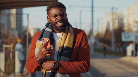Sick poor afro-american man suffering flu sneezing allergy coughing into napkin Stock Footage 121472128