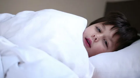 Sick sneezing boy in bed Stock Footage 45788884