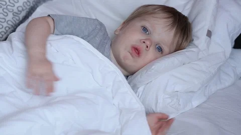 Sick two years old child boy on the bed at home - coughing 스톡 동영상 93864002