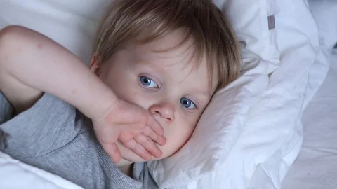 Sick two years old child boy on the bed at home - coughing  Stock Footage 93864452
