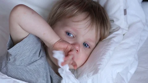 Sick two years old child boy on the bed at home - coughing Stock Footage 93864489