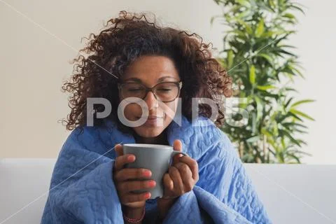 Sick woman drinks hot drink during cold weather Stock Photos