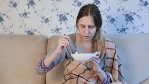Sick woman eats soup Stock Footage 84848829