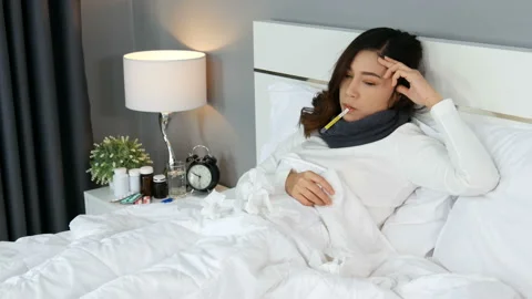 Sick woman using thermometer to checking her temperature and her headache and fe Video stock 130486733